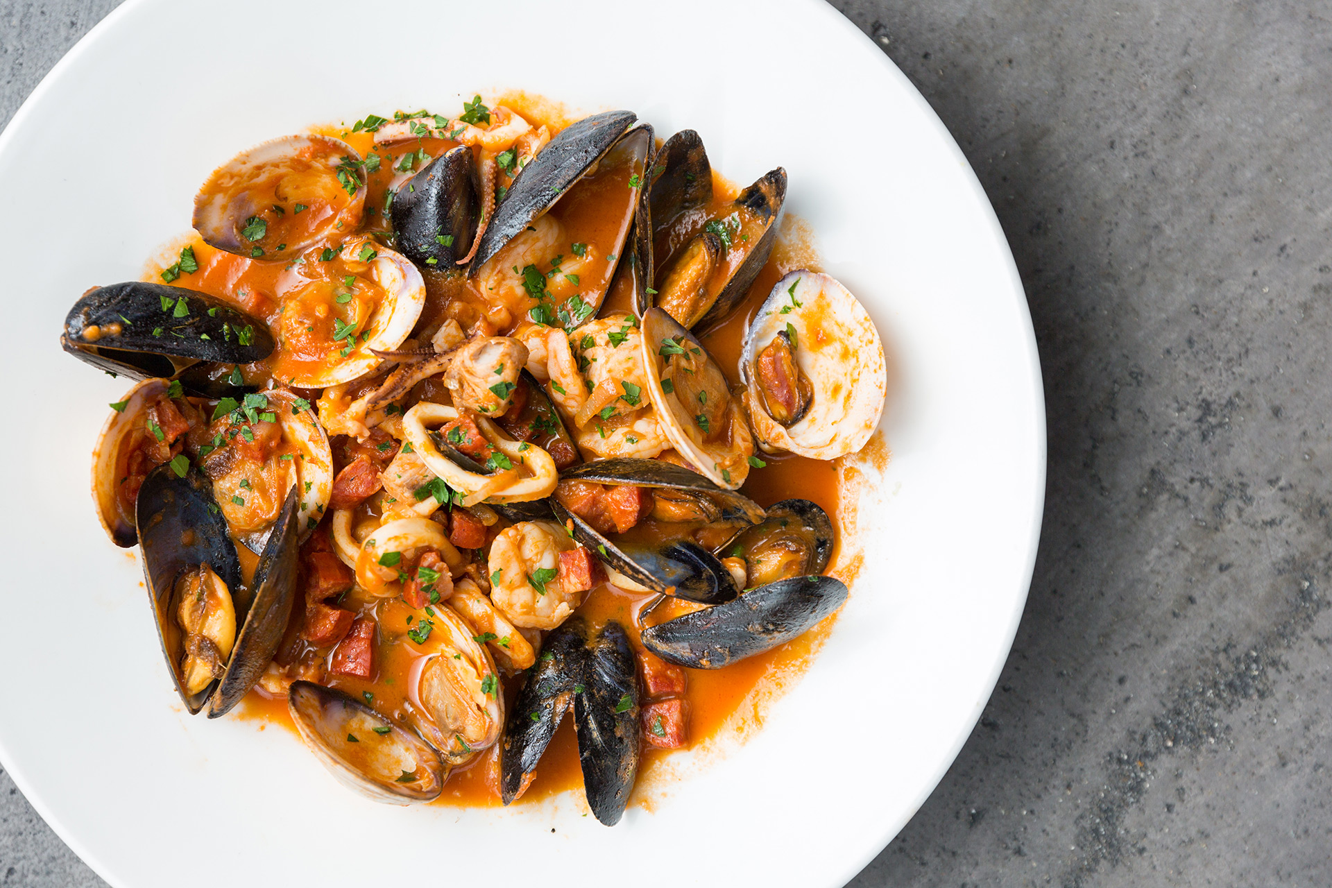 Plate of mussels, clams, shrimp and octopus in red sauce